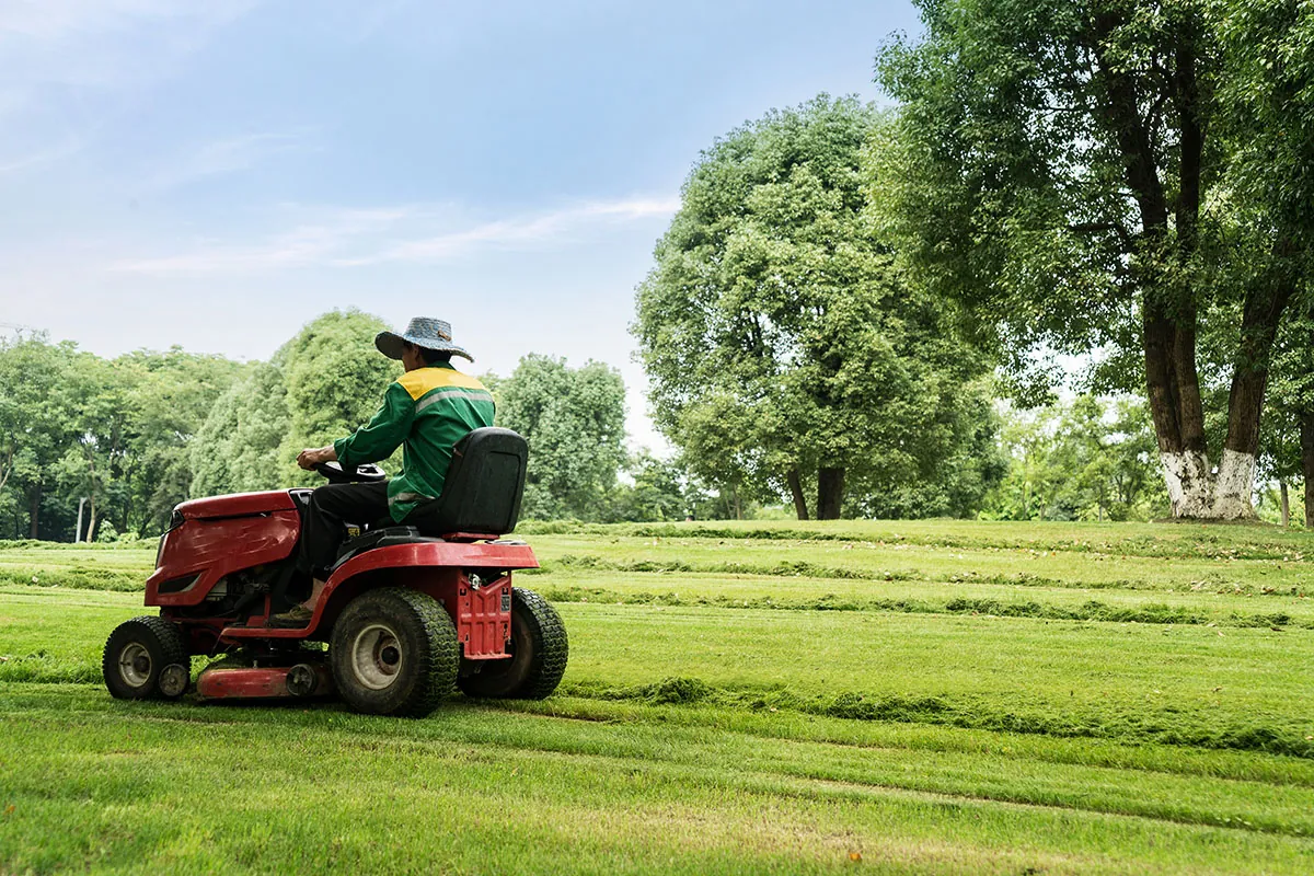 Riding mower cutting a large commercial lawn - commercial lawn care in Moses Lake, WA