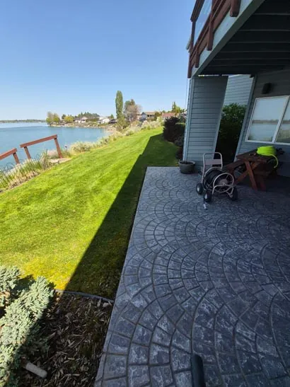Waterfront lawn next to a stamped concrete patio in Moses Lake, WA