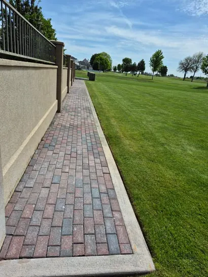 Brick paver walkway along a freshly mowed lawn in Moses Lake, WA