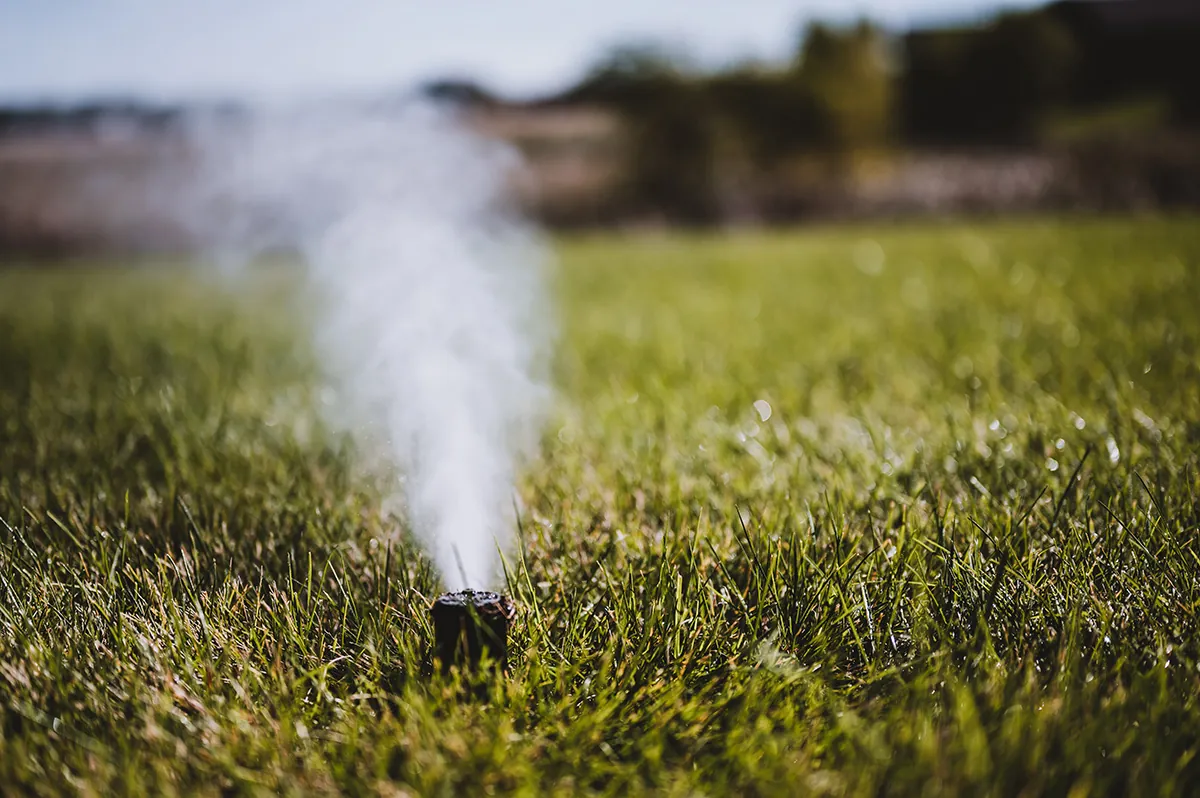 Sprinkler head blowing out water during irrigation winterization in Moses Lake, WA